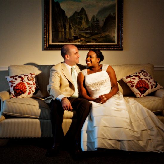 bride and groom lounge on their couch