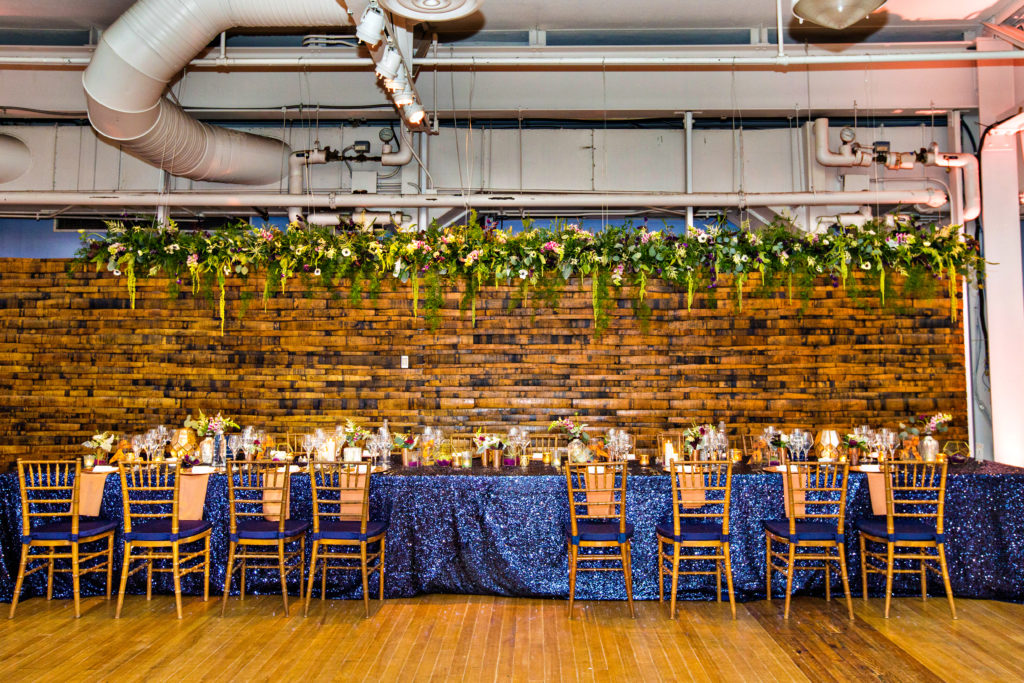 AVAM wedding reception head table chandelier floral copper navy