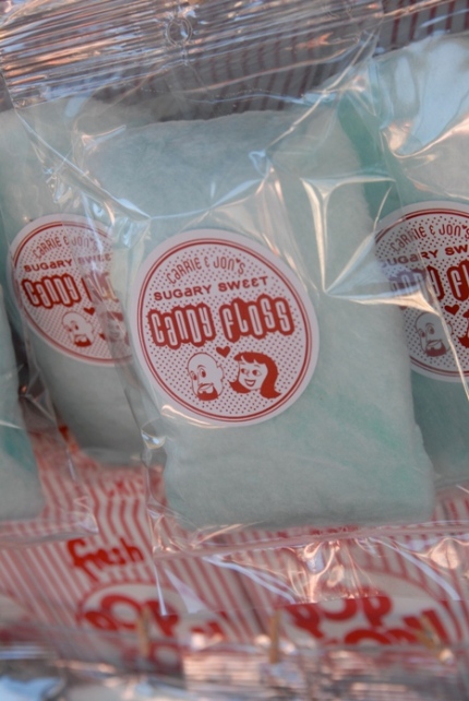Blue cotton candy with a red label featuring cartoon renderings of the bride & groom