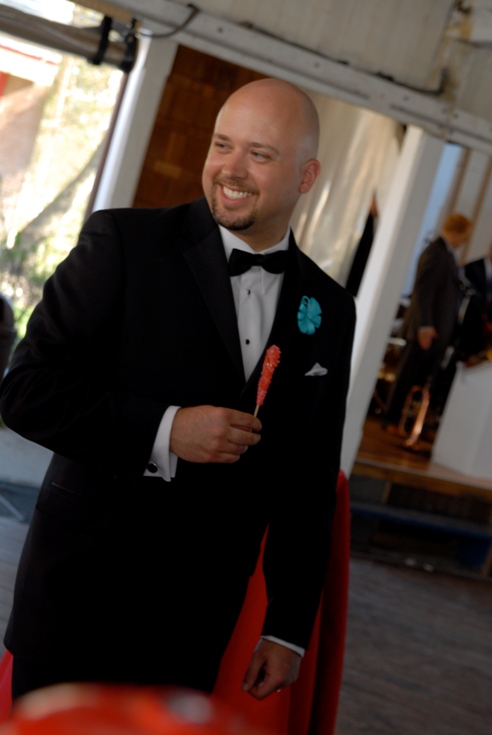 Groom eating a stick of red rock candy