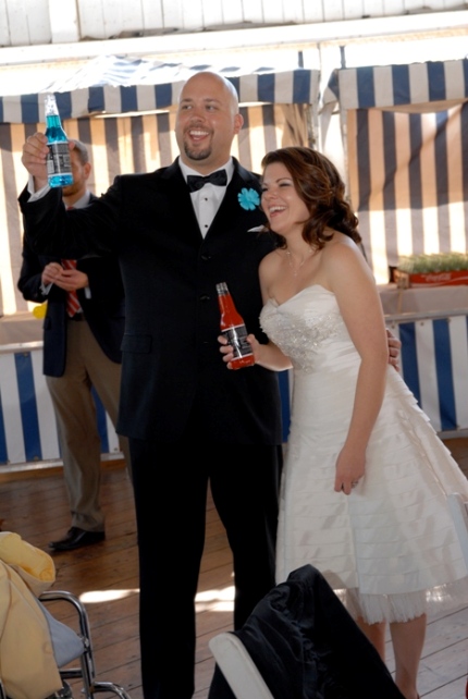 Bride and groom drink jones soda while listening to the best man's toast