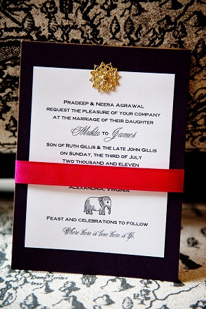 black and white invitation with pink ribbon belly band and a gold seal