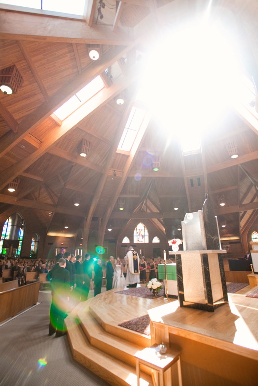 wide shot of the wedding ceremony with light from the skylight