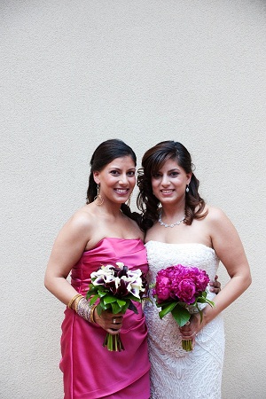 the bride and her sister, the maid of honor with pink, white and purple bouquets