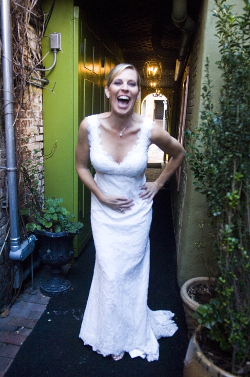 bride laughs while standing in an alley in Alexandria VA