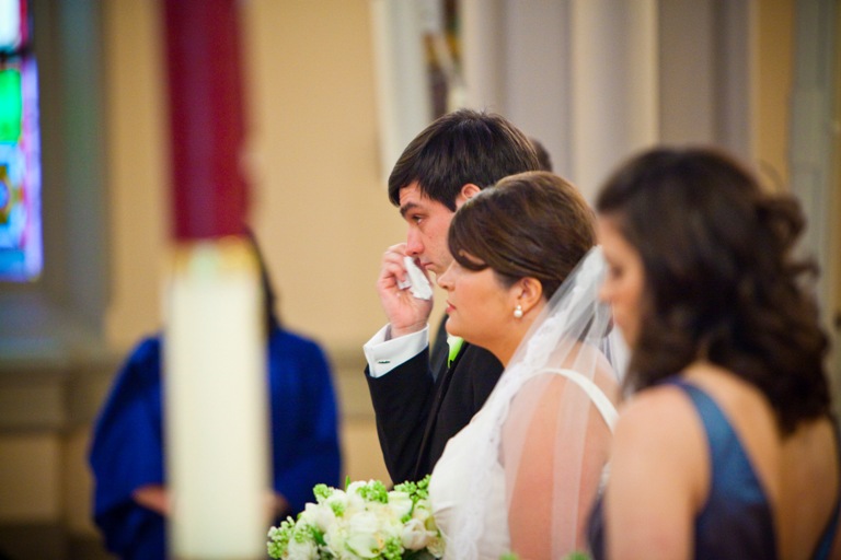groom wipes away a tear at the start of the wedding ceremony