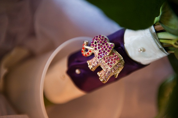 an elephant brooch on the bridal bouquet