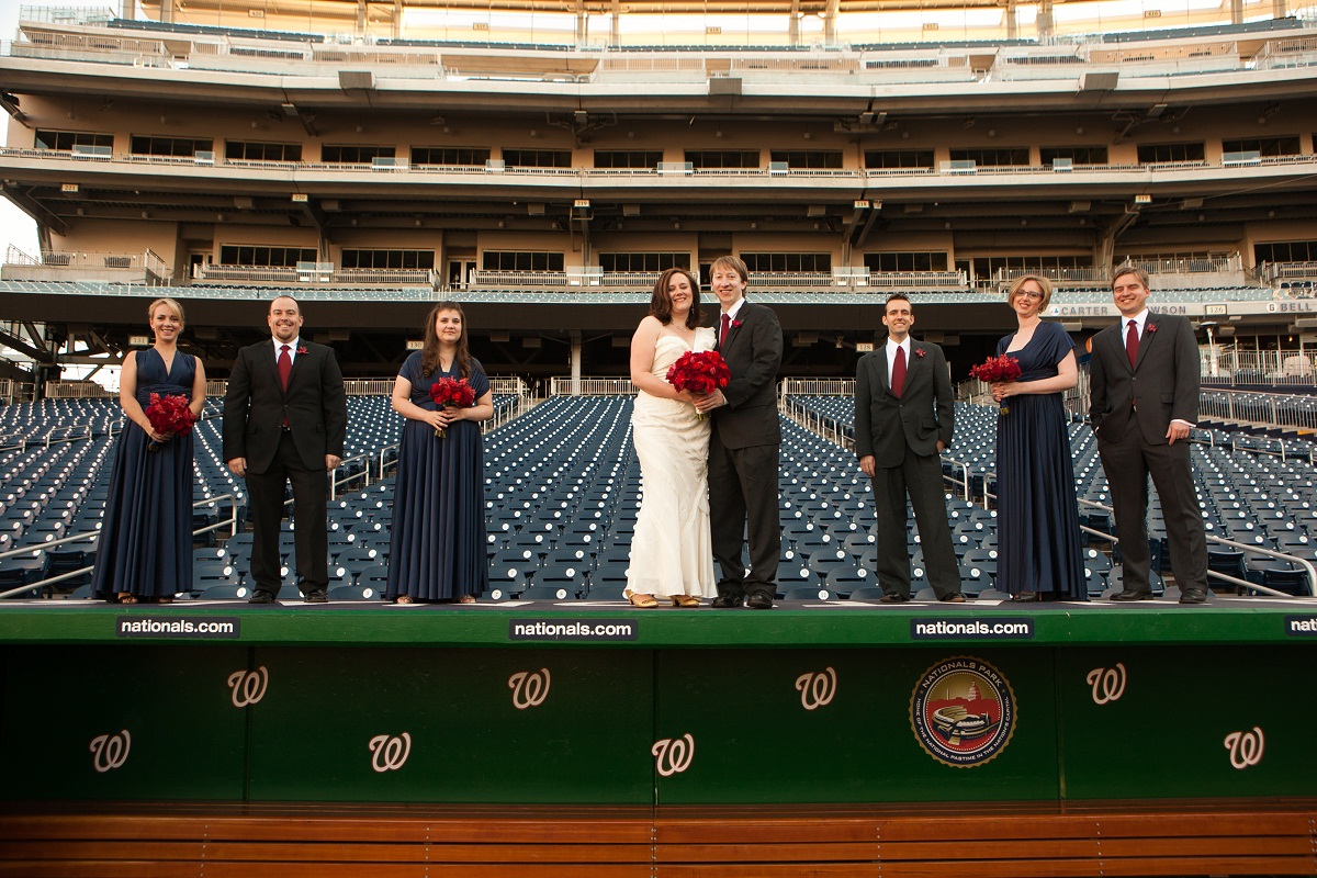 wedding party portrait stand on the top of the dugout