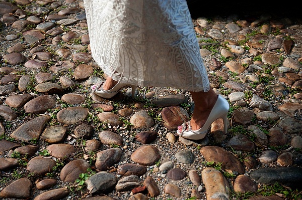 bride walks on cobblestone