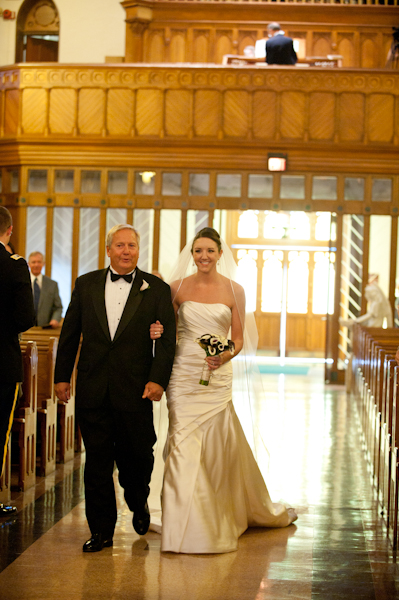 the bride and her father walk down the aisle