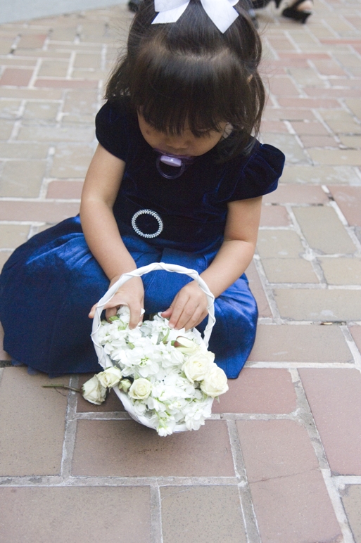 flower girl plays with her basket of flowers