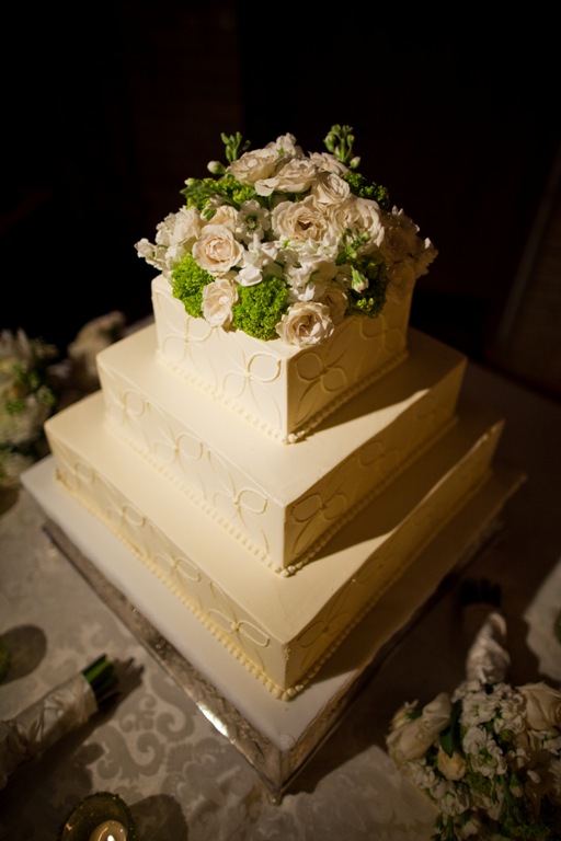 White wedding cake with floral topper