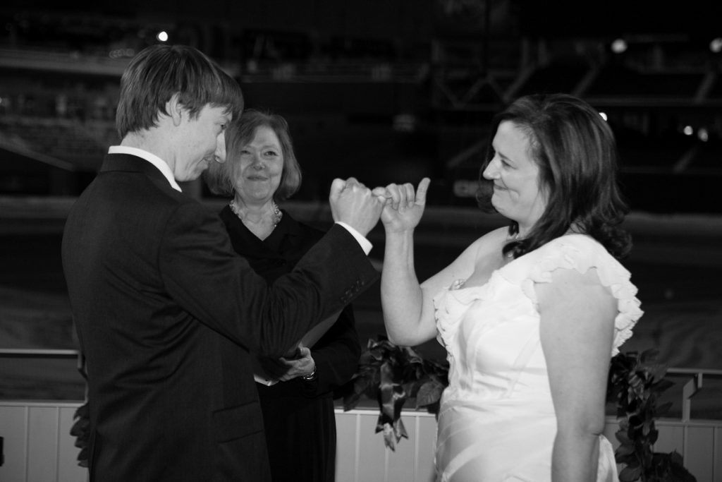 Nationals Park wedding - bride and groom make a pinkie swear at the end of the ceremony