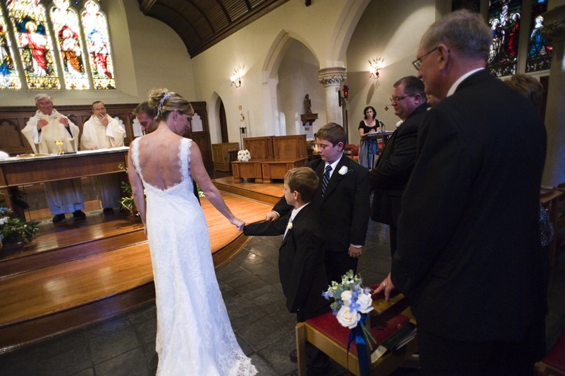 bride and the groom's son share a fist bump during the ceremony