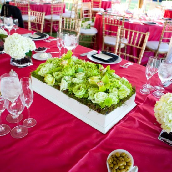 Pink linen, lime green pave flowers, gold chairs, white base plate with black napkin