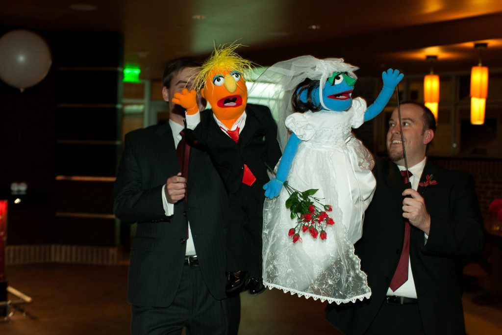 Nationals Park wedding - groomsmen carry in the couple's custom made muppets during the introductions