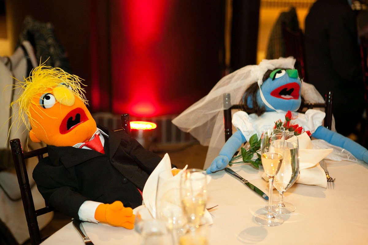 the couple's muppets sit at their sweetheart table