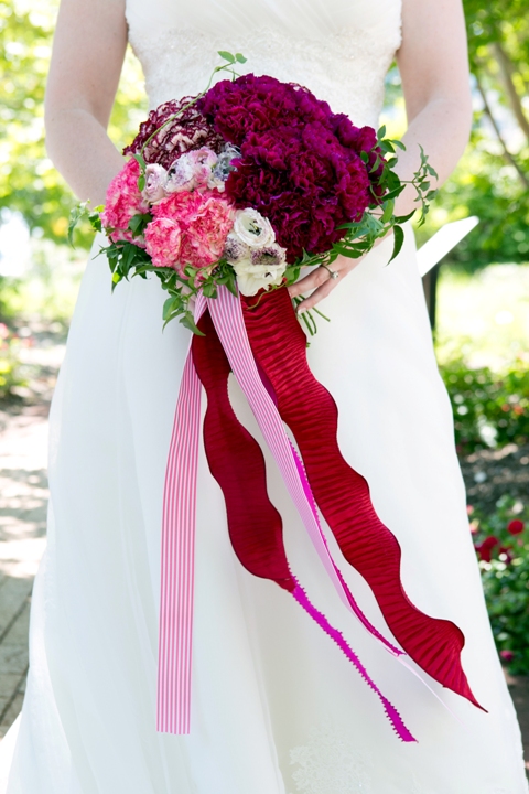 a pink and burgundy color blocked bridal bouquet