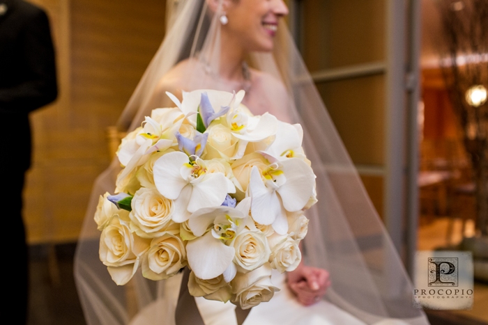 A modern white bridal bouquet with orchids
