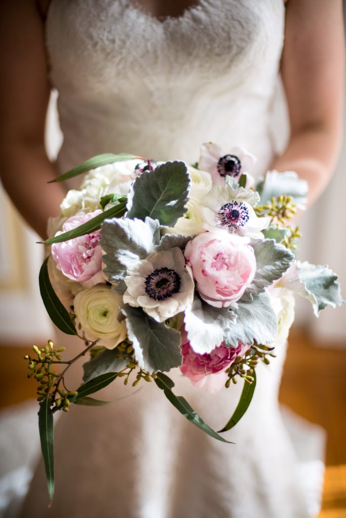 A white, pink and gray bridal bouquet 