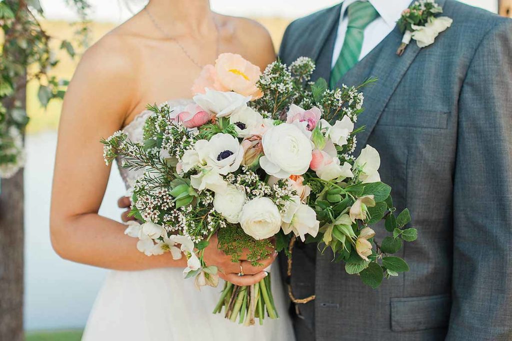 a white bridal bouquet with peach and blush 