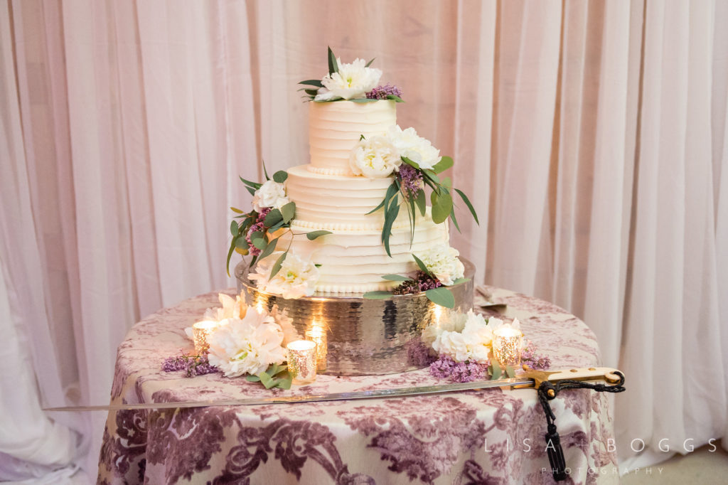 White buttercream wedding cake with purple accents