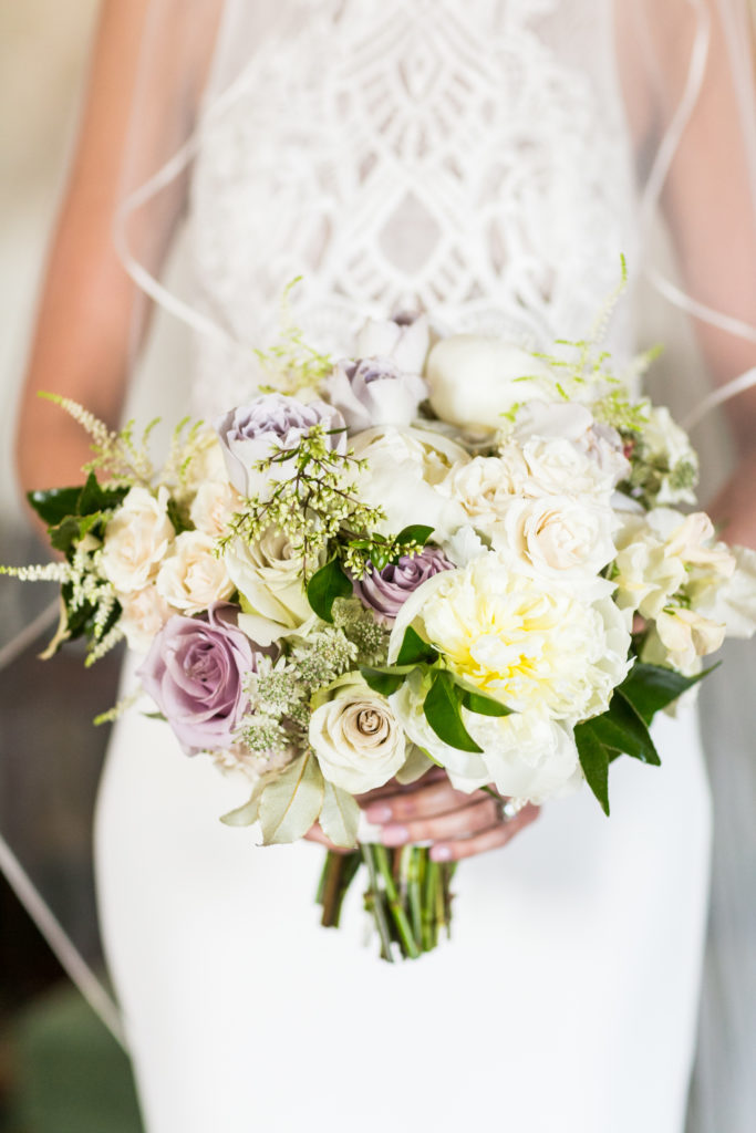 A white bridal bouquet with hints of dusty lavender