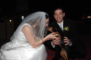 min pin with bride and groom at wedding