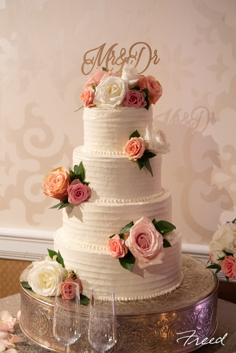 white buttercream wedding cake with flowers 