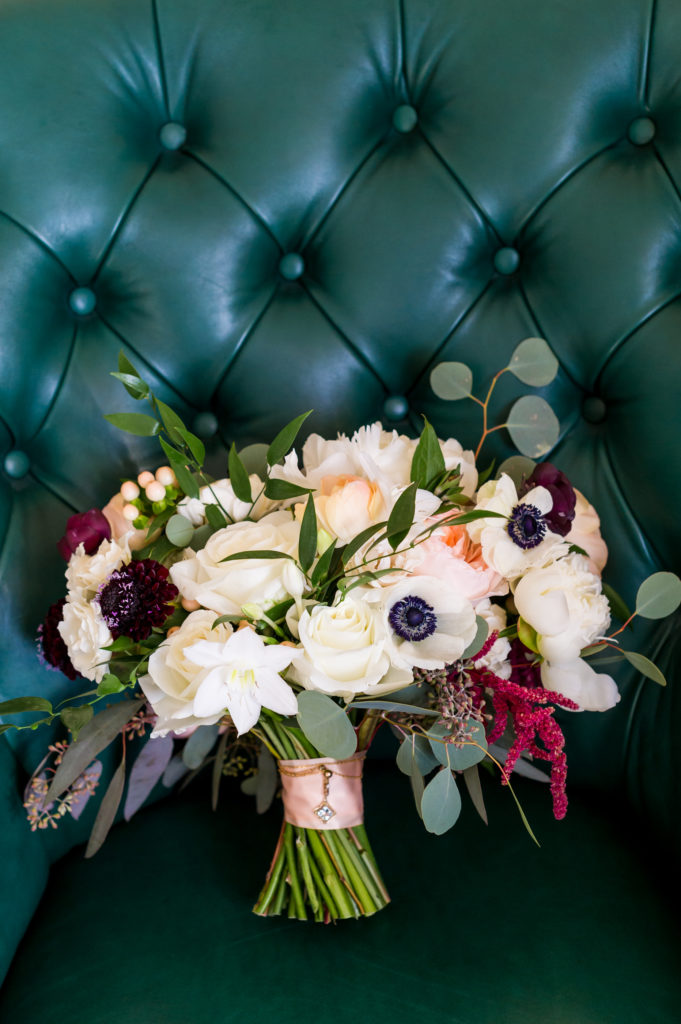 A white, peach and burgundy bouquet