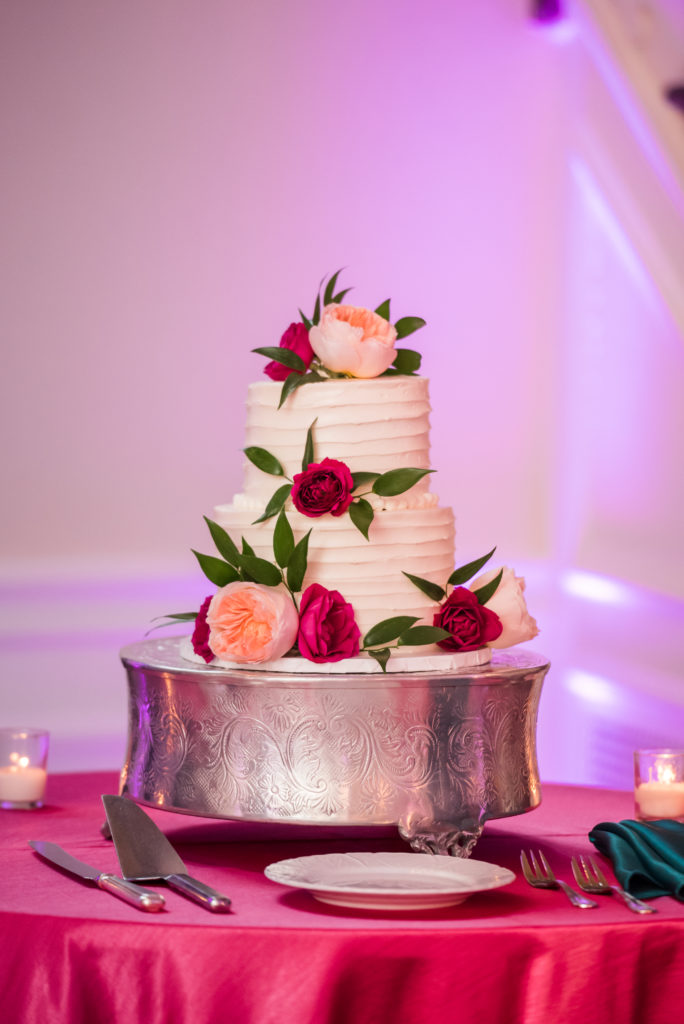 white buttercream wedding cake with flowers