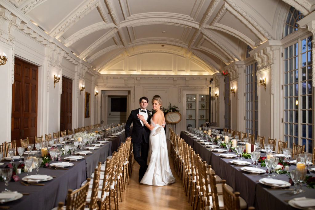wedding reception in O'Byrne Gallery at DAR in Washington DC with two very long rectangular tables with gray linens and gold chairs. coordinated by Bellwether Events. 