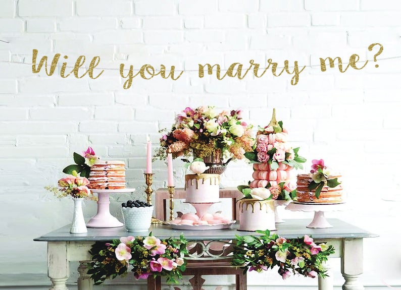 will you marry me gold glitter banner  - ways to propose at home
