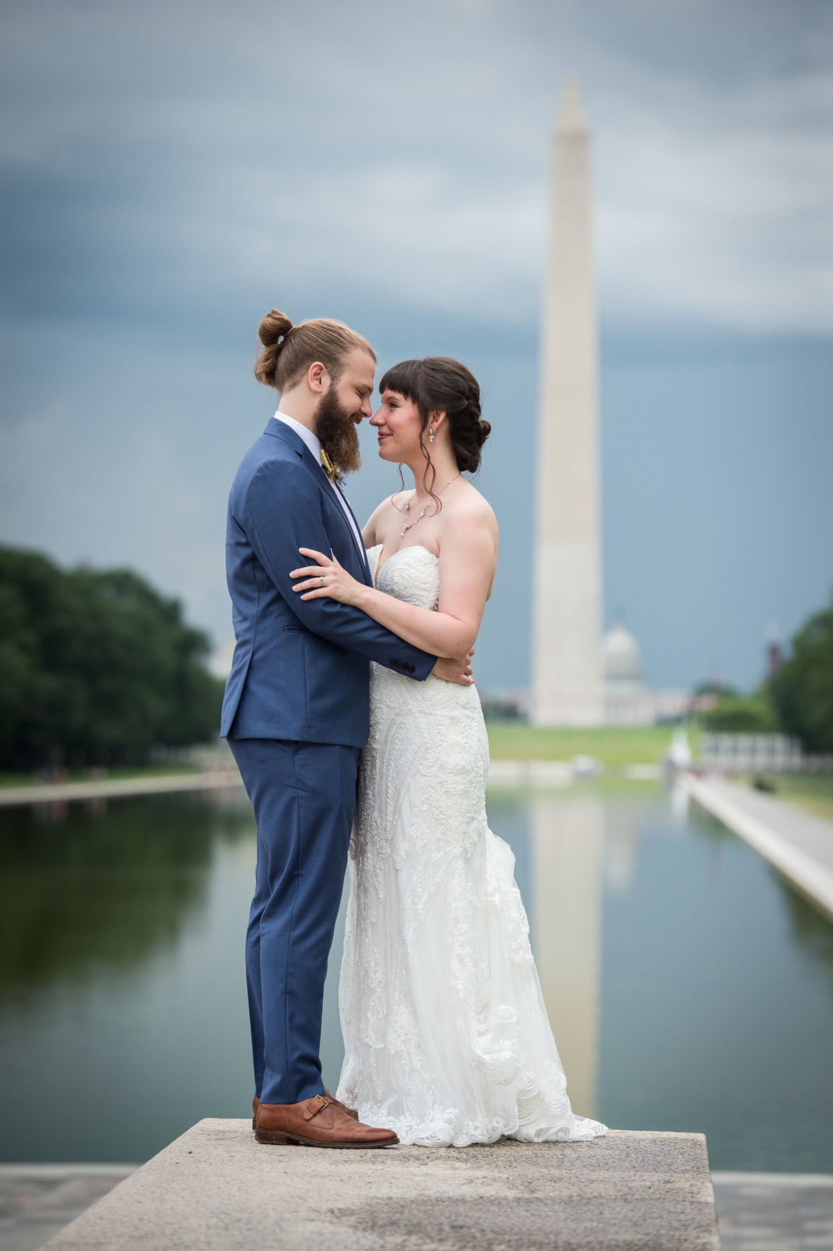 dc micro wedding - couple standing in front of the reflecting pool with the Washington Monument in the background