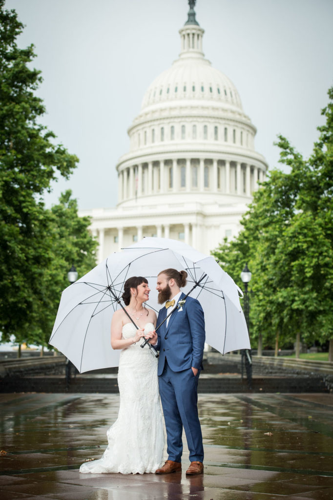 DC micro wedding - couple under umbrellas in front of the Capitol Building