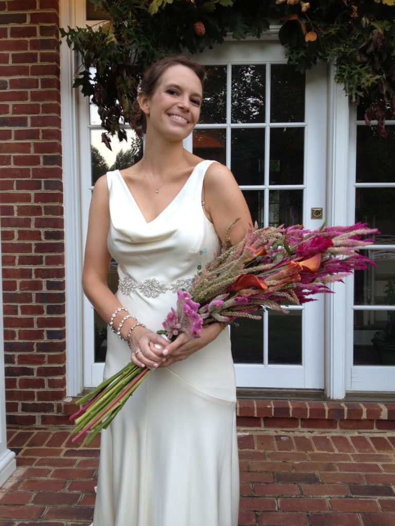 a bride holds and oversized, colorful bouquet