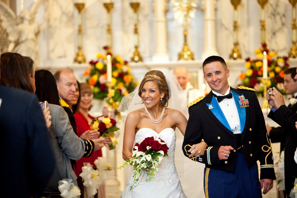 bride and military groom recess from their Catholic wedding ceremony