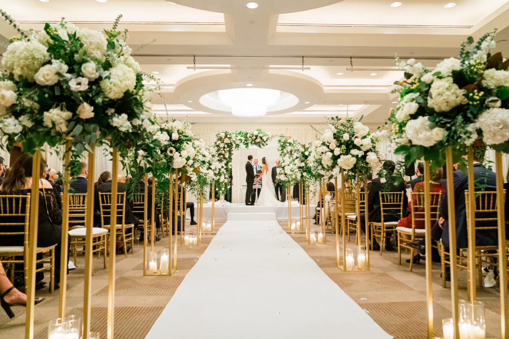 The Park Hyatt DC gold winter wedding chuppah with white and green flowers