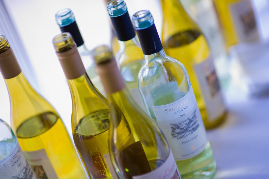 open bottles of assorted white wines
