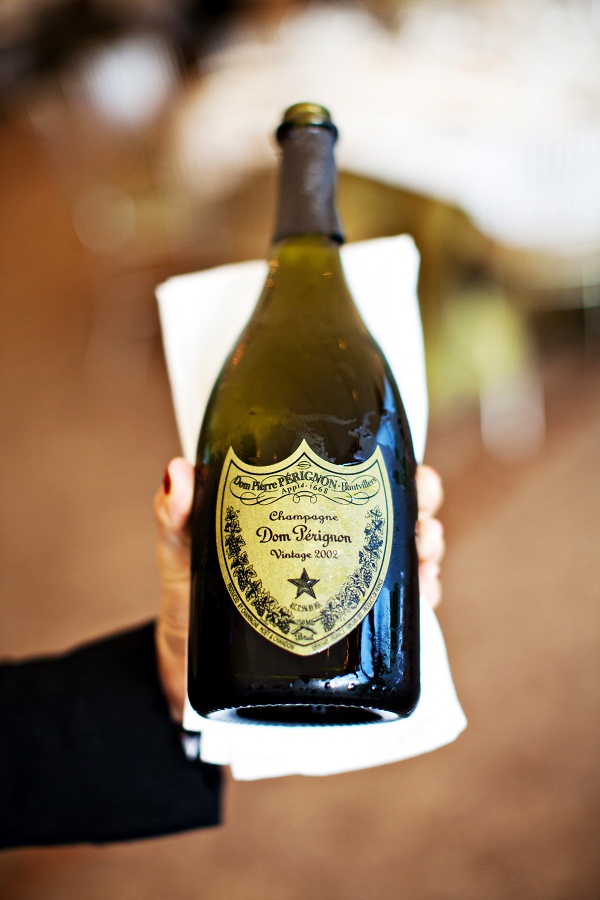 2002 Dom Perignon bottle held  by a waiter