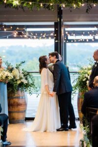 District Winery DC wedding ceremony first kiss