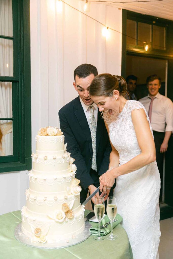 Maryland Tented wedding reception - summery florals - Marlborough Hunt Club - cake cutting