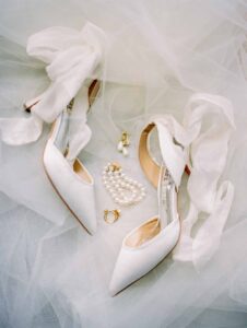 white bridal shoes and pearls