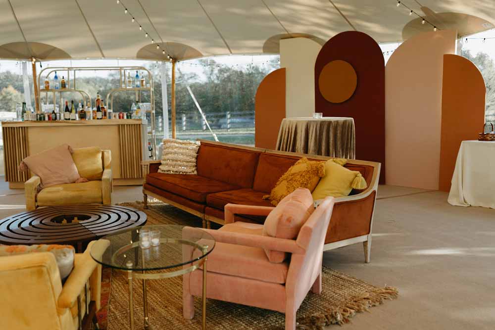 terracotta blush marigold lounge and back drop and slatted wood bar Boho Tented Wedding at Maryland Private Home