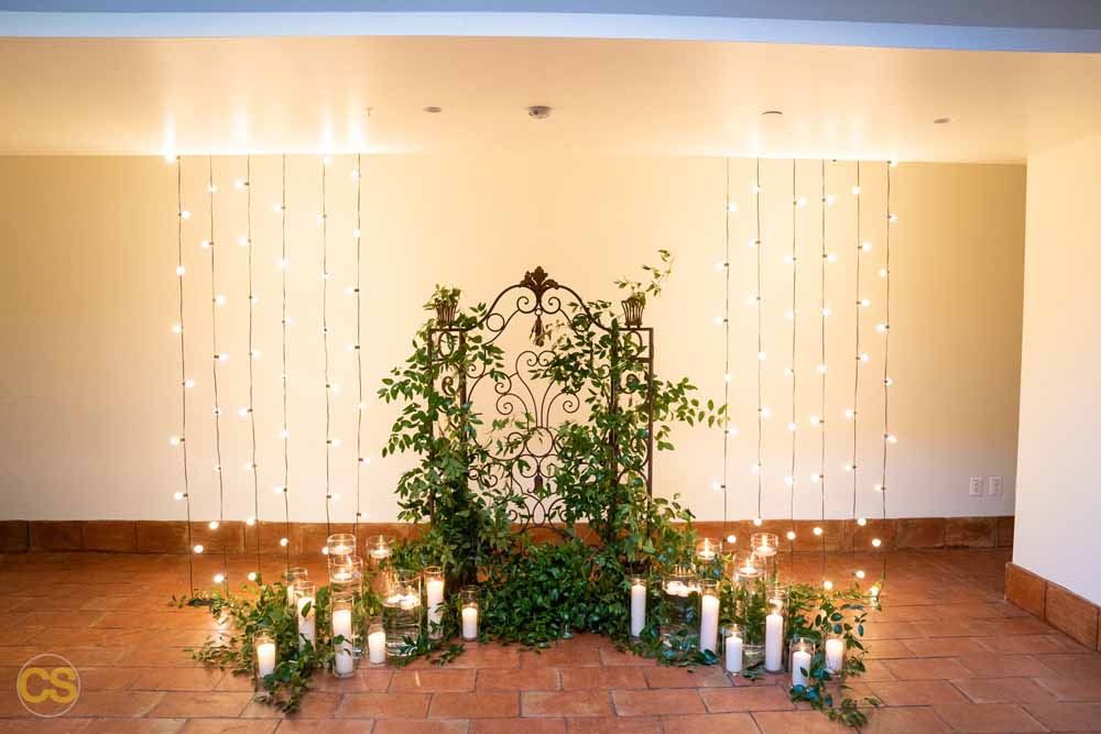 Vintage iron garden gate with lights, greenery and candles The Line hotel wedding DC with dog