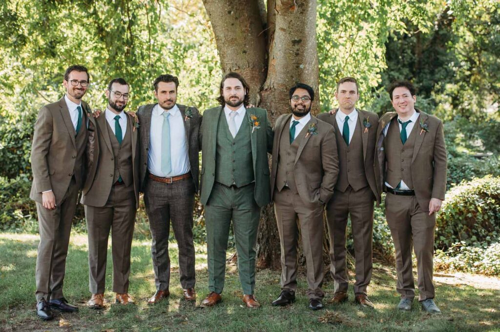 groomsmen in brown suits, groom in evergreen suit 