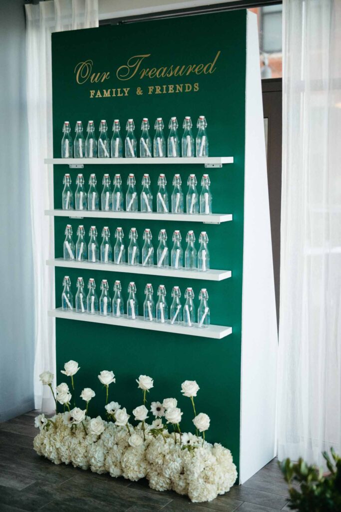 message in a bottle escort card wall - green and white wedding