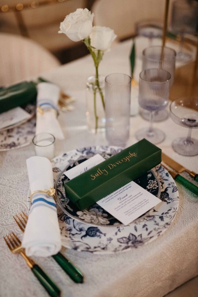 blue, white and green wedding table setting with menu card and favor box