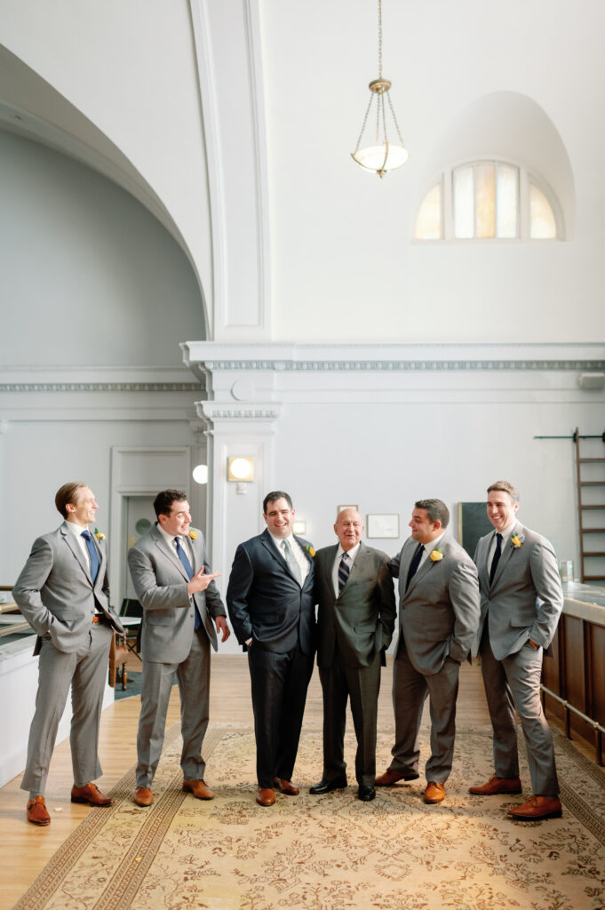 groomsmen in gray suits, groom in charcoal suit