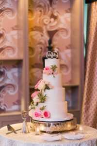 white wedding cake with pink flowers